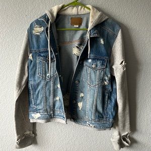 Distressed Jean Jacket with sweatshirt material sleeves and hood.